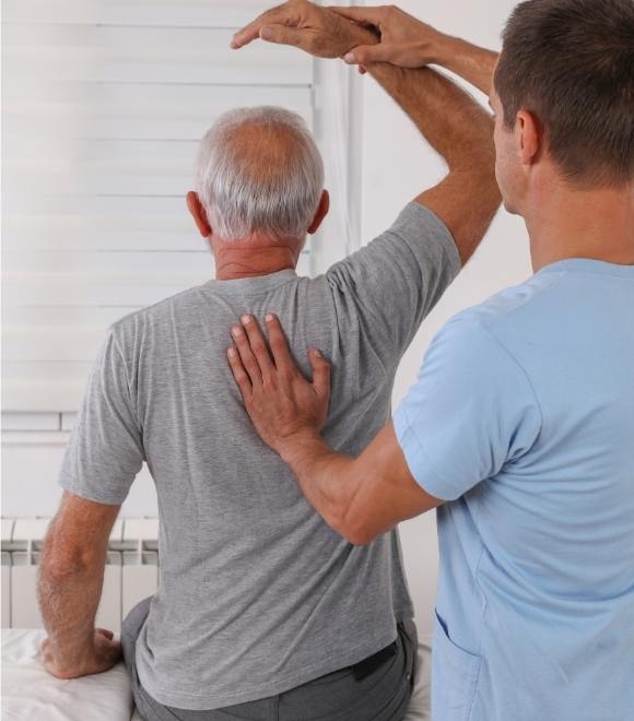Physiotherapist helping patient with rehabilitation exercises